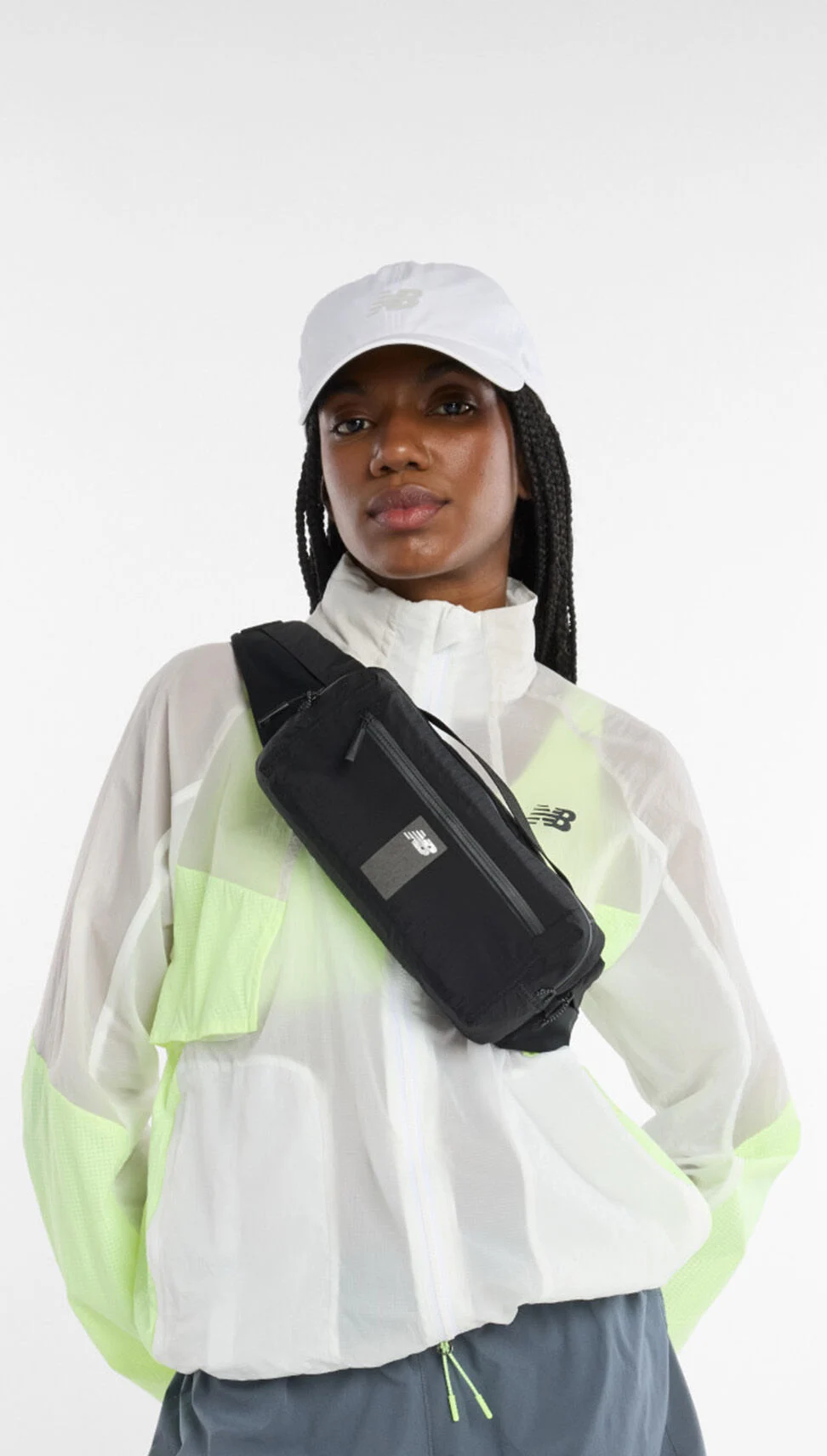 A woman wearing the run sling belt bag as a cross-body bag. 