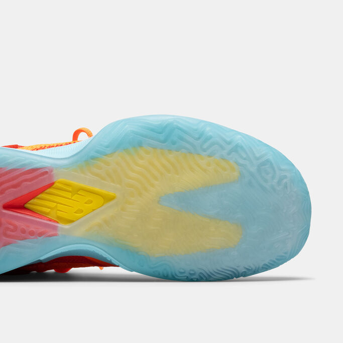 Light blue and yellow sole of the shoe sitting on grey background.