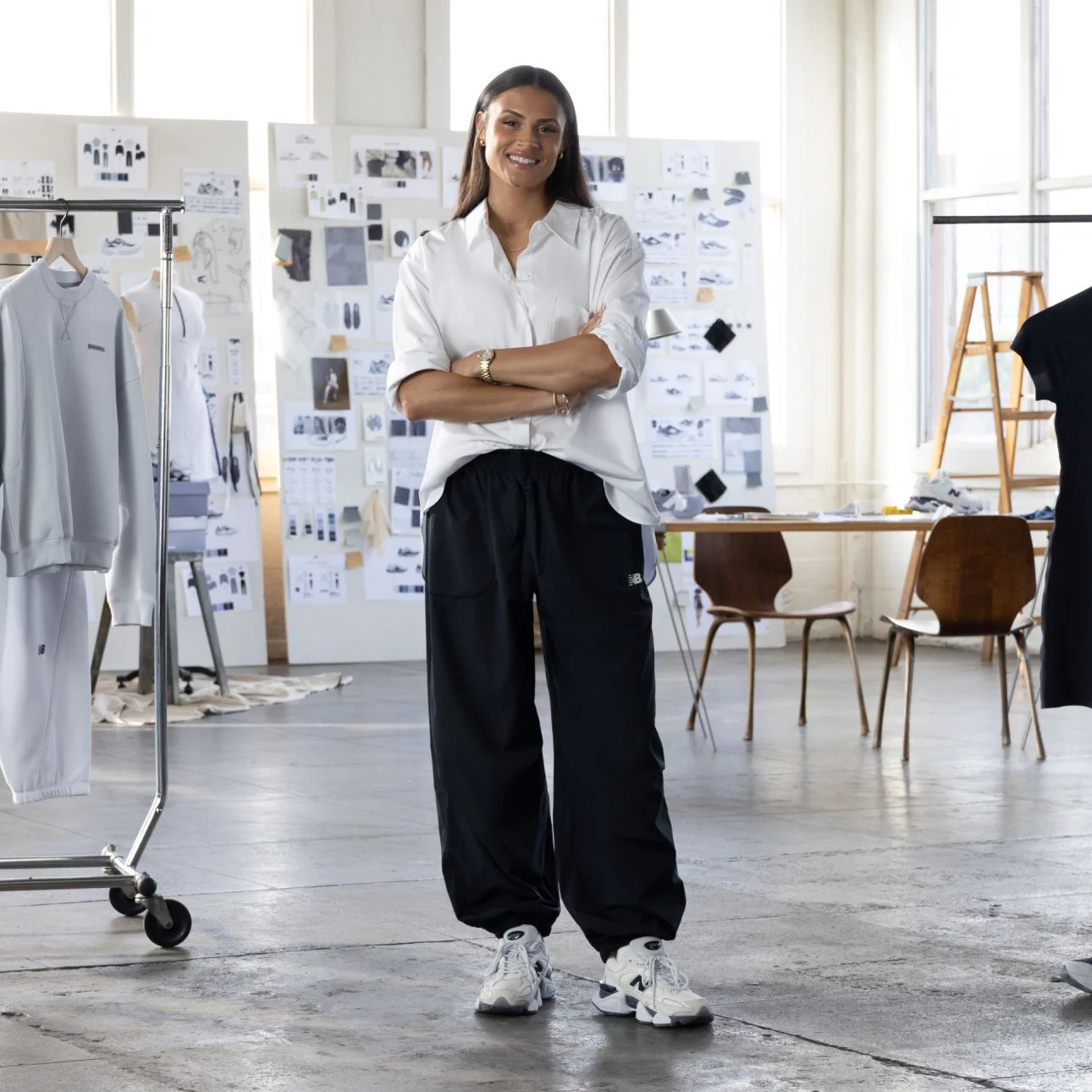 Sydney Levrone standing in front of her apparel collection.