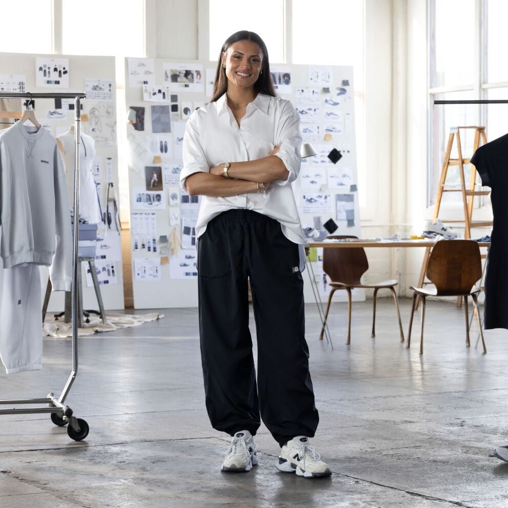  Sydney Levrone standing in front of her apparel collection.