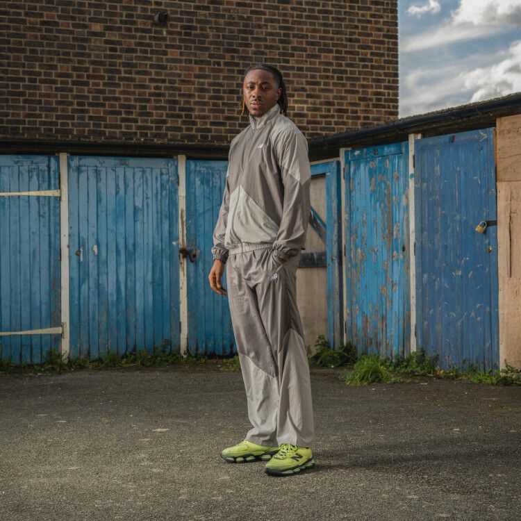 Eberechi Eze wearing the lime green shoes with his hands in his pockets 