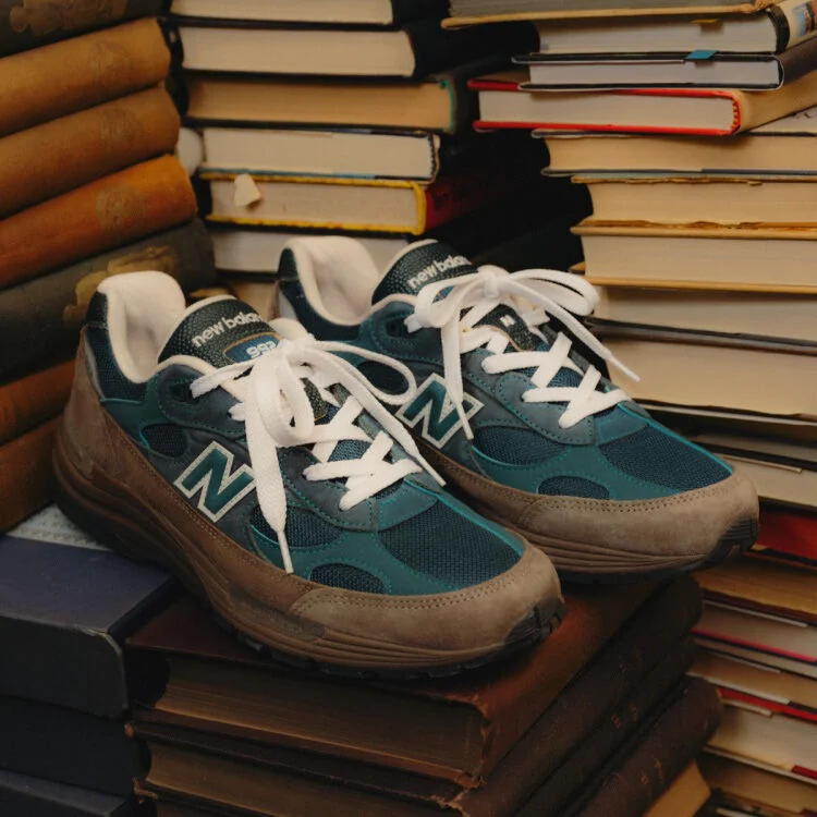 Green and brown shoes sitting on a pile of books