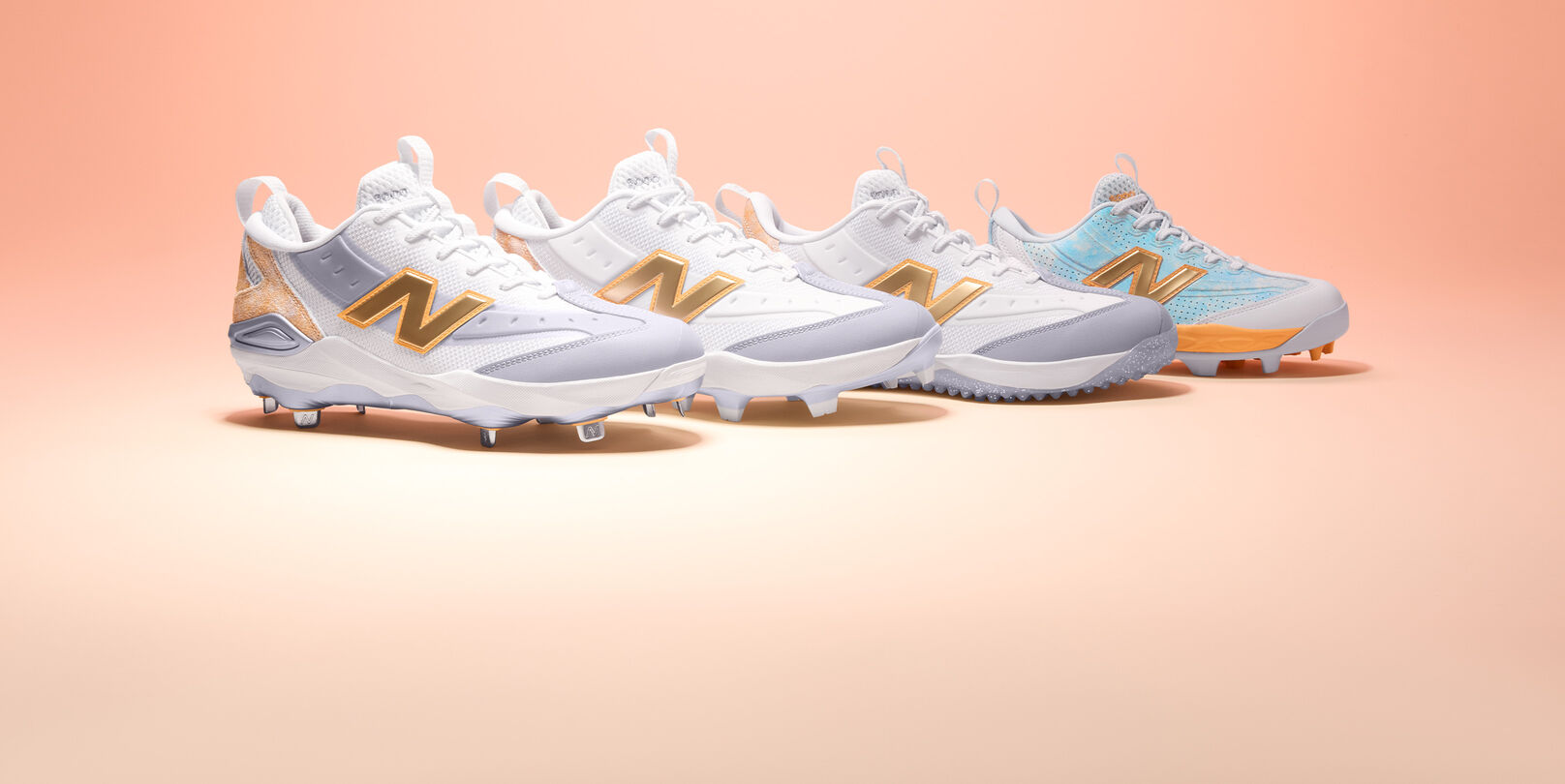 Lateral view of four baseball cleats on a light pink gradient background.