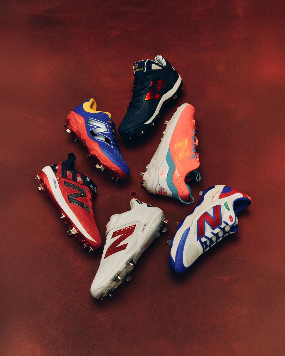 Five colorful baseball shoes arranged in a circular formation against a smoky red background, each in different color combinations including blue, orange, red, and white.