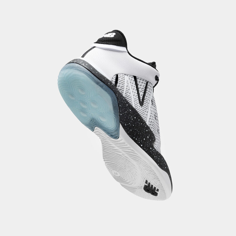 Floating basketball shoe that is facing away focusing on the sole.