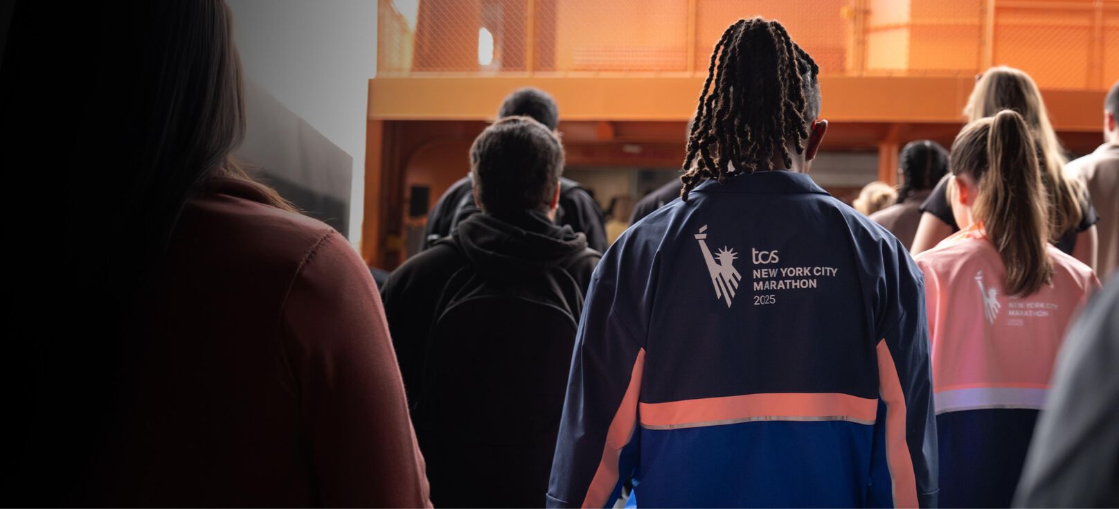 Man and woman wearing marathon jackets on the ferry