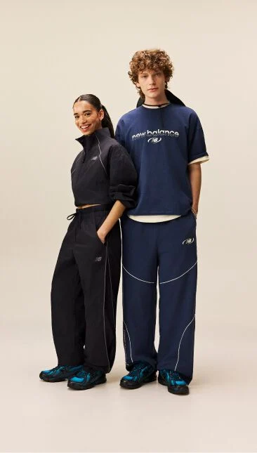  Man and woman standing with their hands in their pockets 