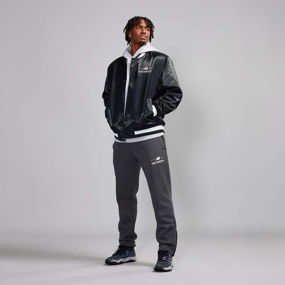 Tyrese Maxey standing in a studio wearing a black jacket.
