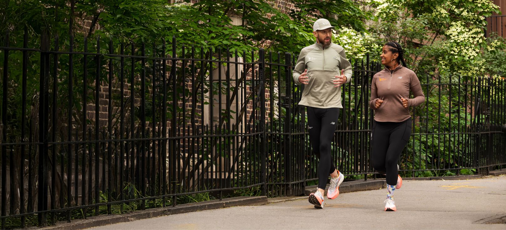 Man and woman running on New York sidewalk