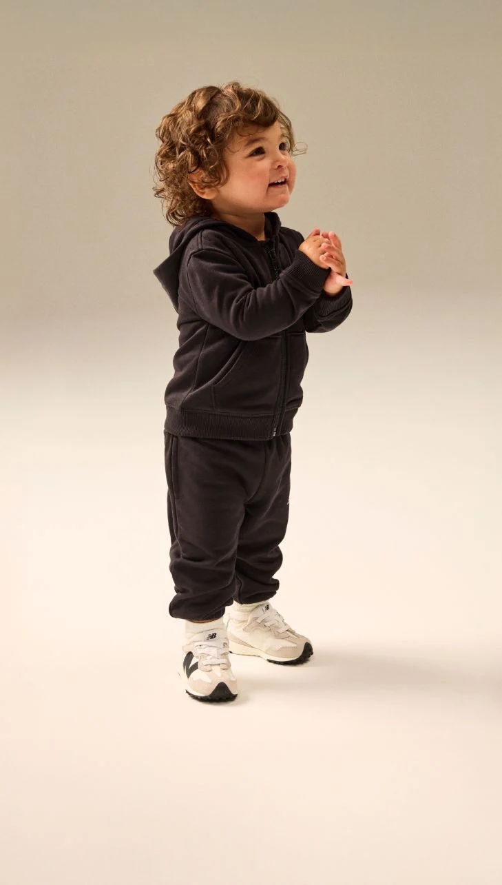 Little kid wearing a pair of 327 shoes.