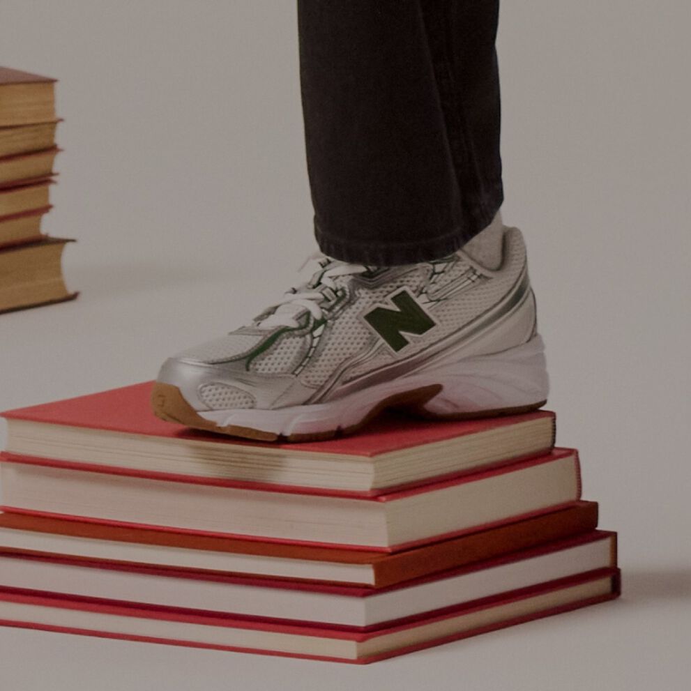 Niño con el pie en una pila de libros.