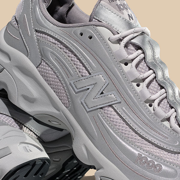 Three quarter turn detail shot of New Balance M1000TE shoes. 