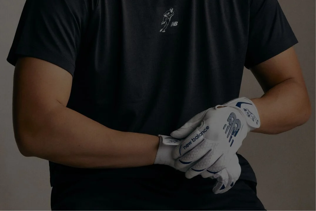 A pair of black and yellow baseball gloves. 