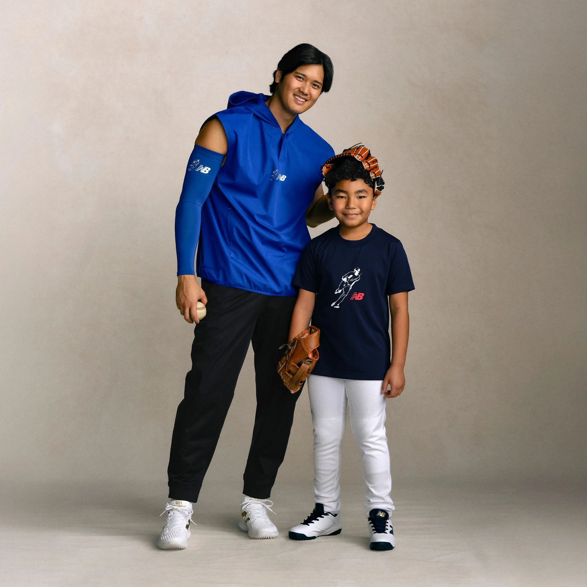 Shohei Ohtani and a child wearing 2026 Shohei Ohtani Signature Collection apparel and footwear.