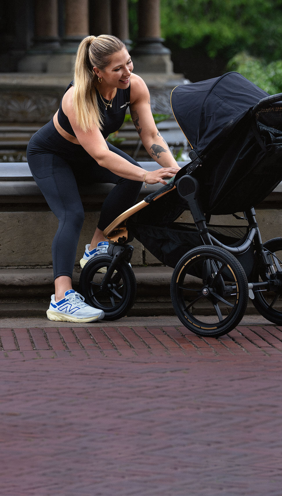 Fitness instructor Selena Samuela wearing blue Fresh Foam 1080v13 shoes sitting in a park.