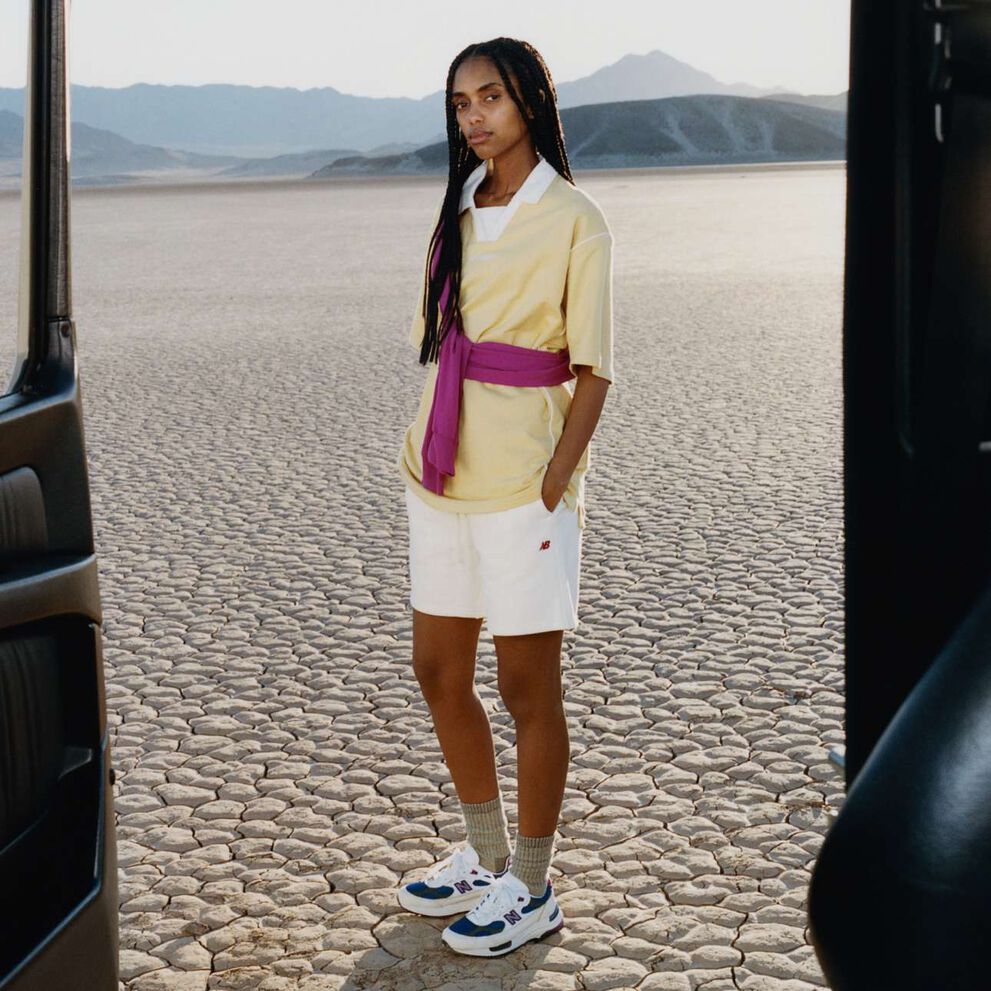 A woman standing in a desert environment.    