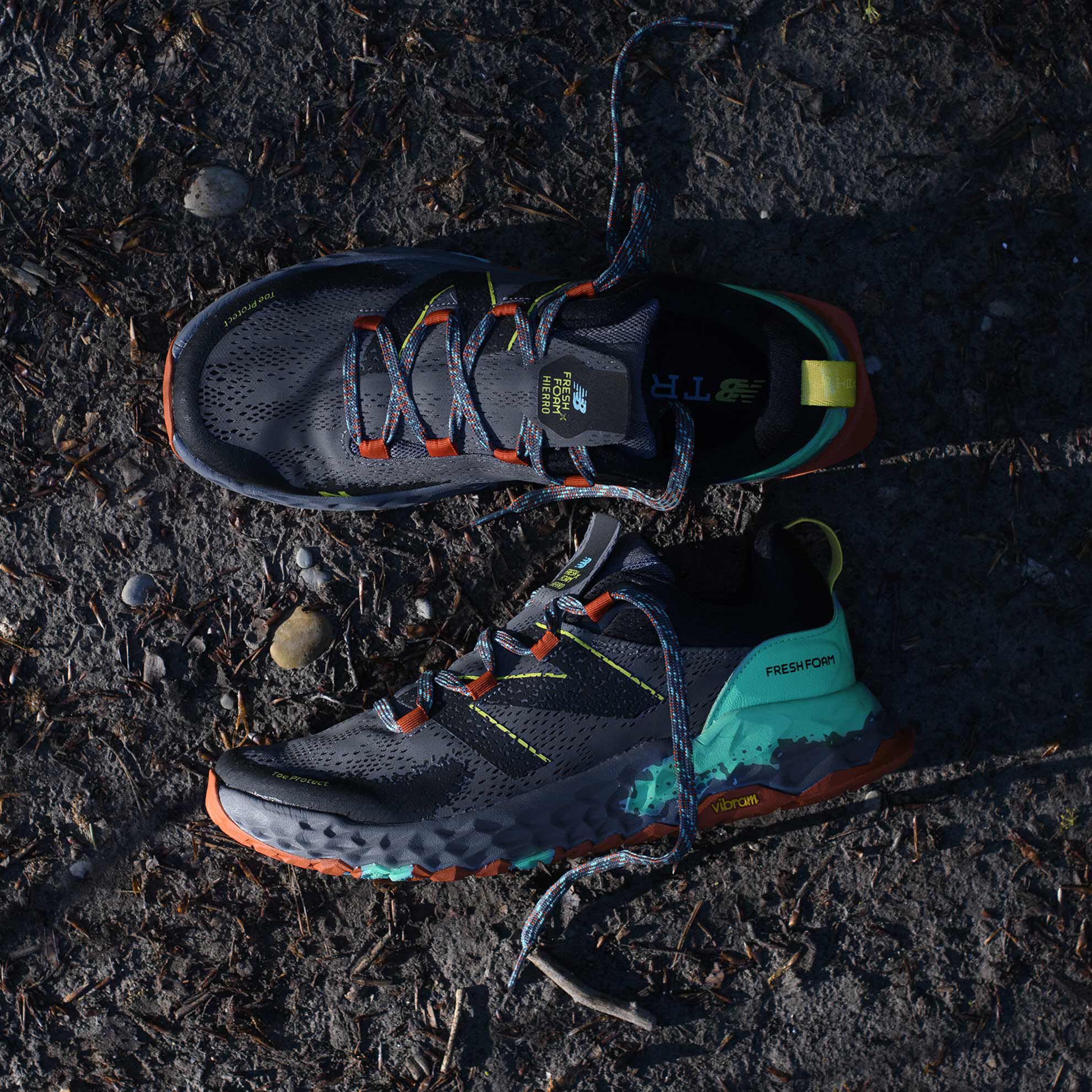 Men’s gray and orange Fresh Foam Hierro trail shoes sitting on trail