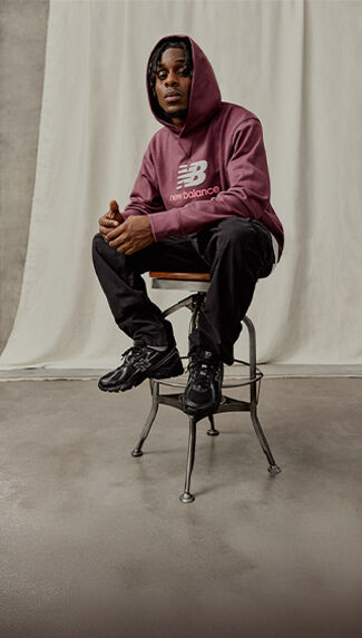 Jeremie Frimpong sitting on chair, hoodie cap on.