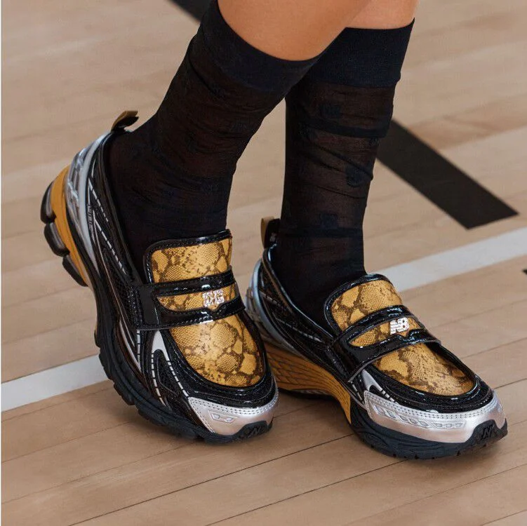 Ganni Loafer on a model with black socks on a gymnasium court.