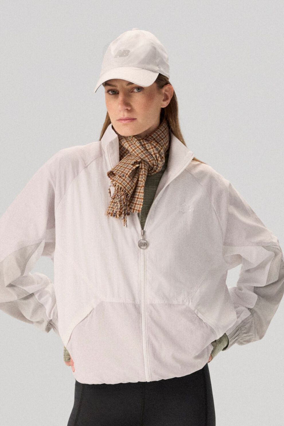 Young lady wearing NB clothing and '47 brand hat.