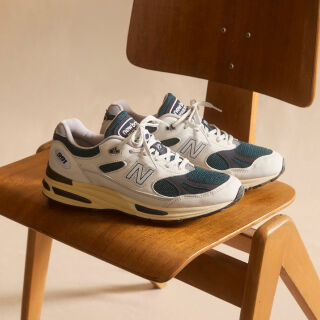 A pair of&nbsp;New Balance Made in UK sneakers in a beige studio environment.