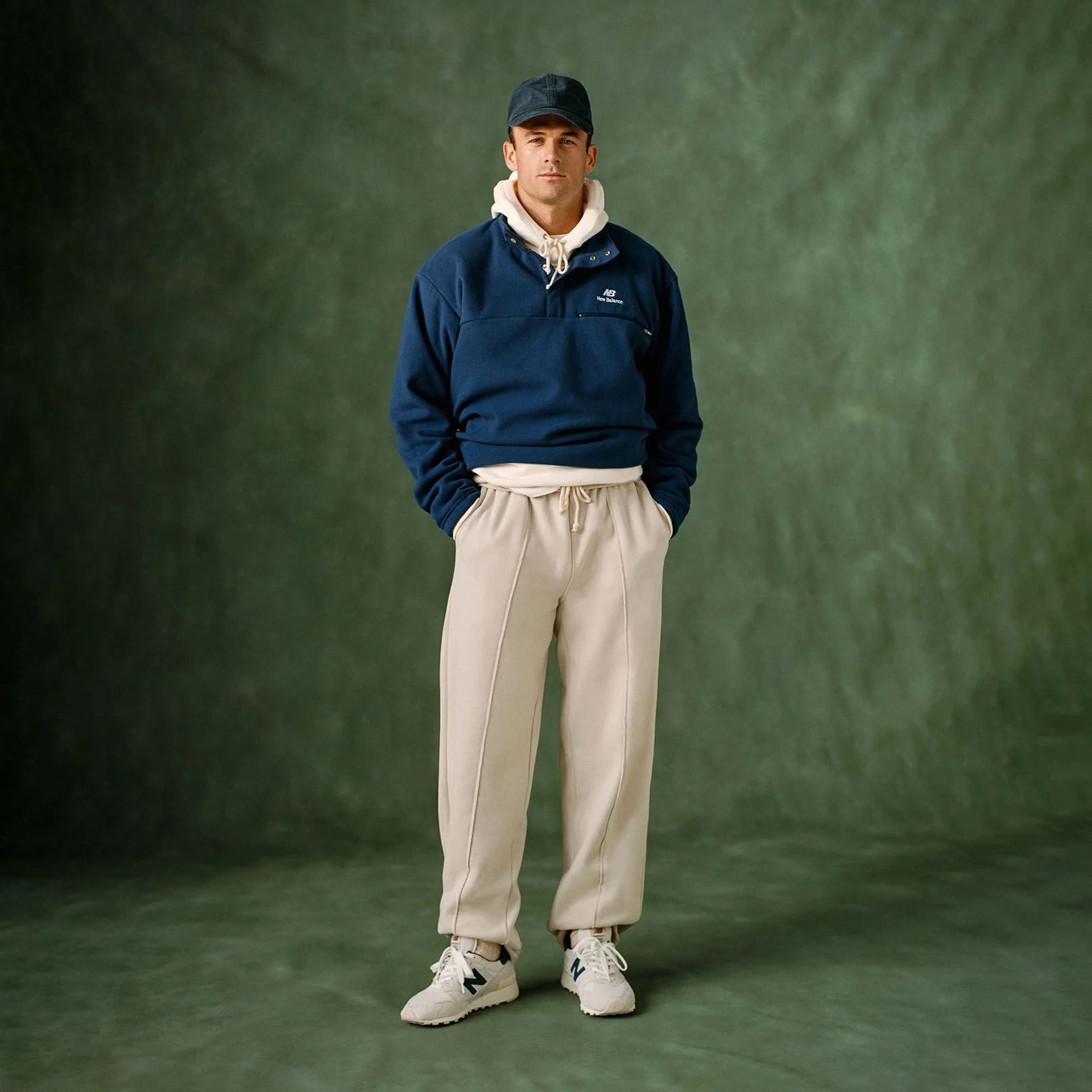Tommy Paul standing against a green studio backdrop.
