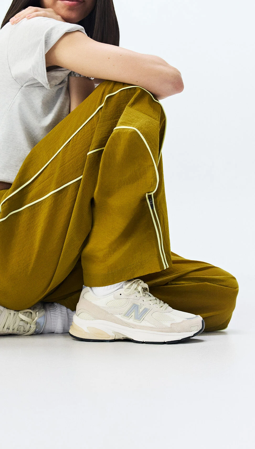  A man wearing New Balance clothing on a white background