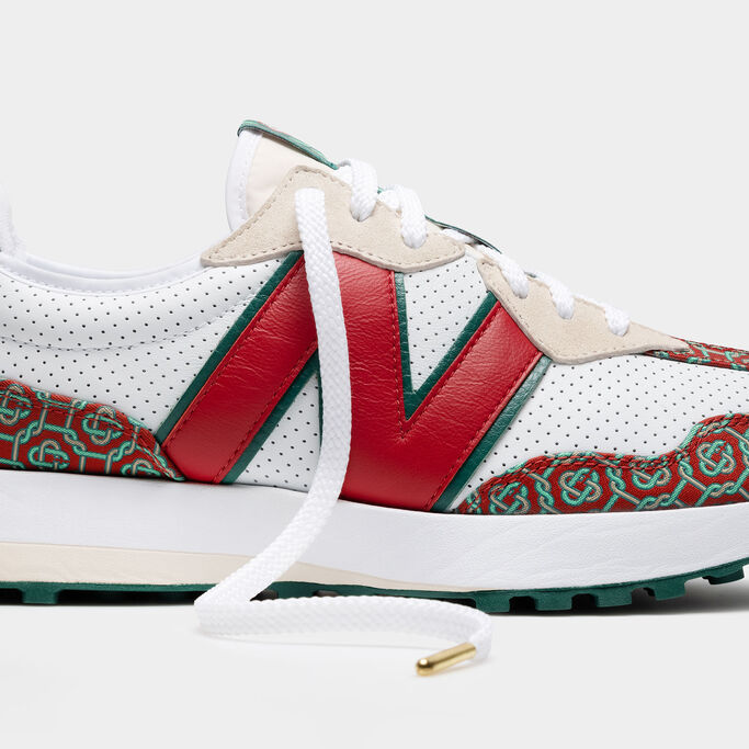 A close-up crop of the side of a white, red, and green NB x Casablanca 327 sneaker