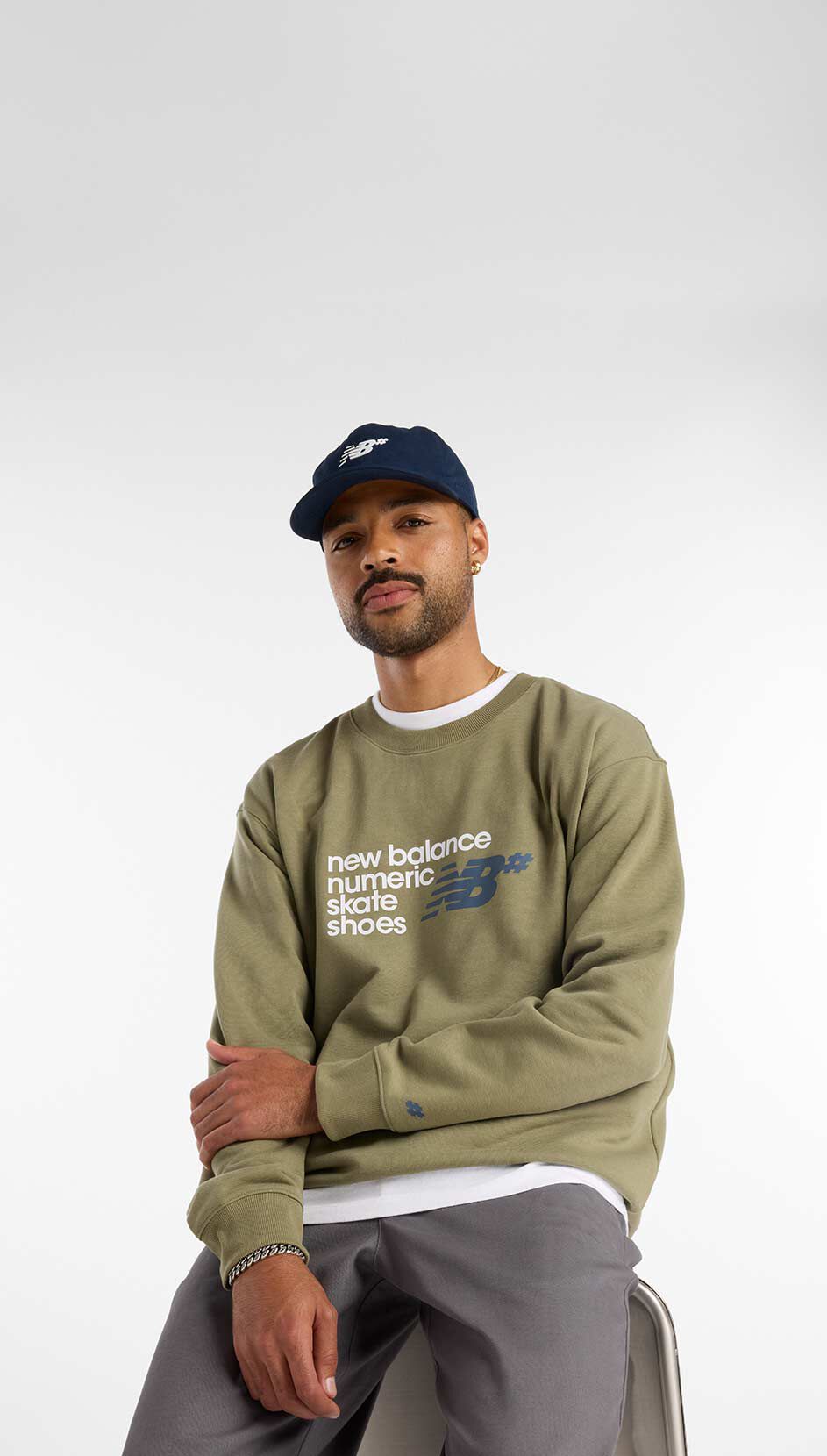  Skateboarder Justin Henry sitting in a studio wearing Numeric apparel. 
