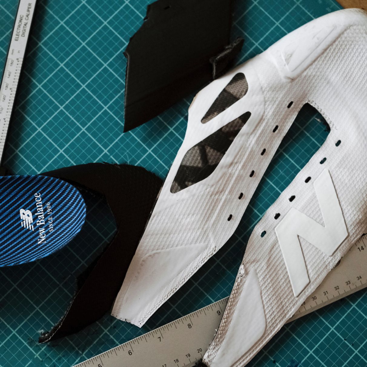 Materials of a football cleat on a cutting mat.