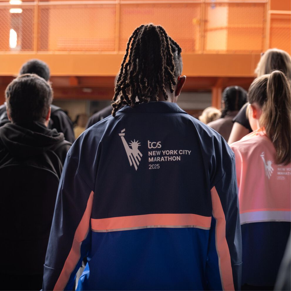 Man and woman wearing marathon jackets on the ferry
