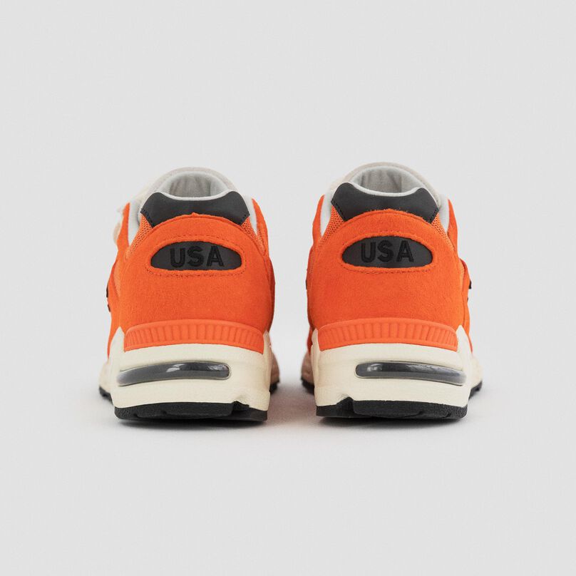 The heels of a pair of orange MADE in USA 990v2.