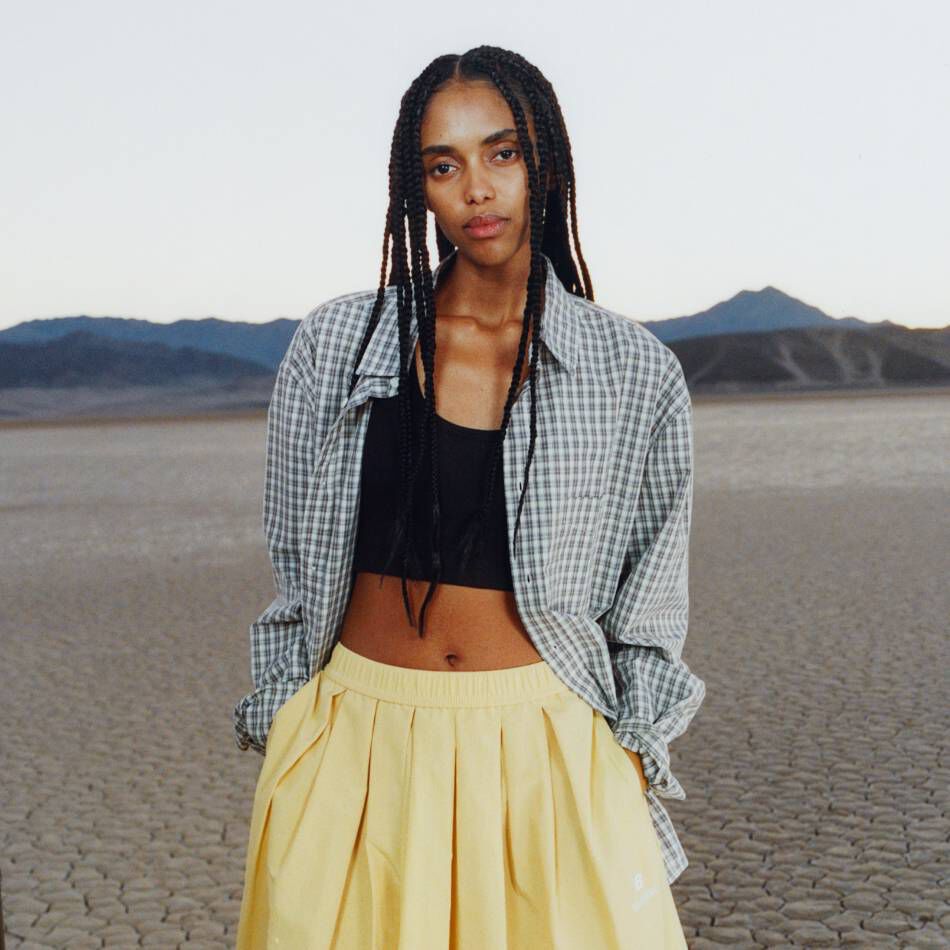 A woman standing in a desert environment. 