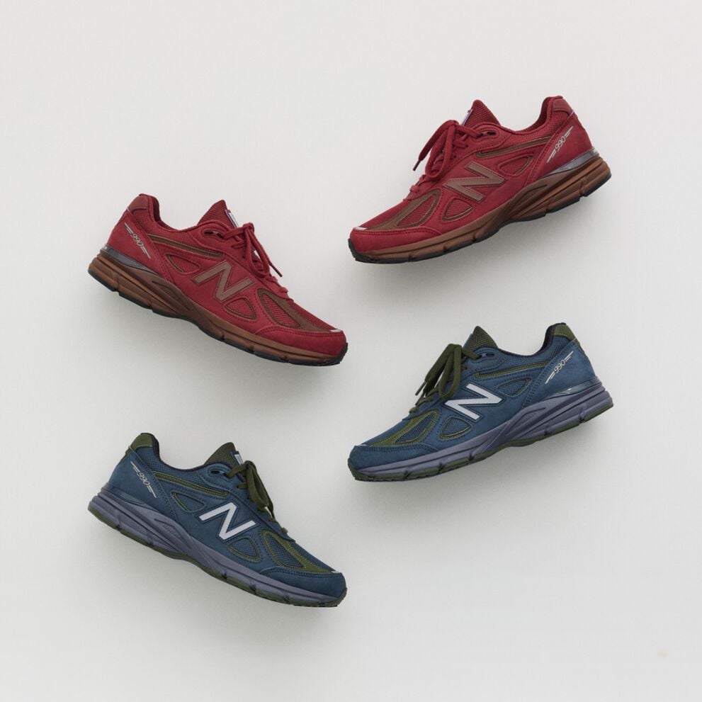 A maroon and navy shoe laying on a grey studio backdrop.