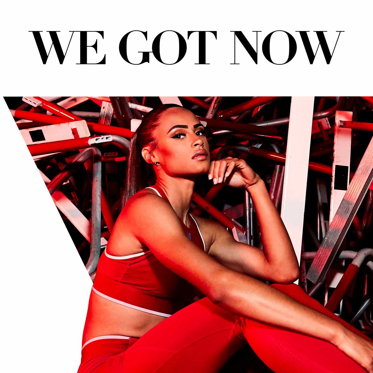 Runner Sydney McLaughlin sitting with hurdles piled behind her