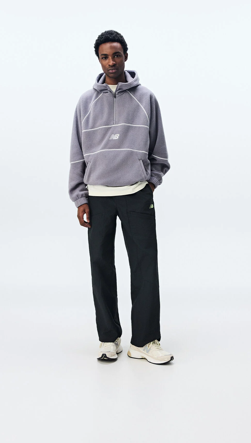  A man wearing New Balance clothing on a white background