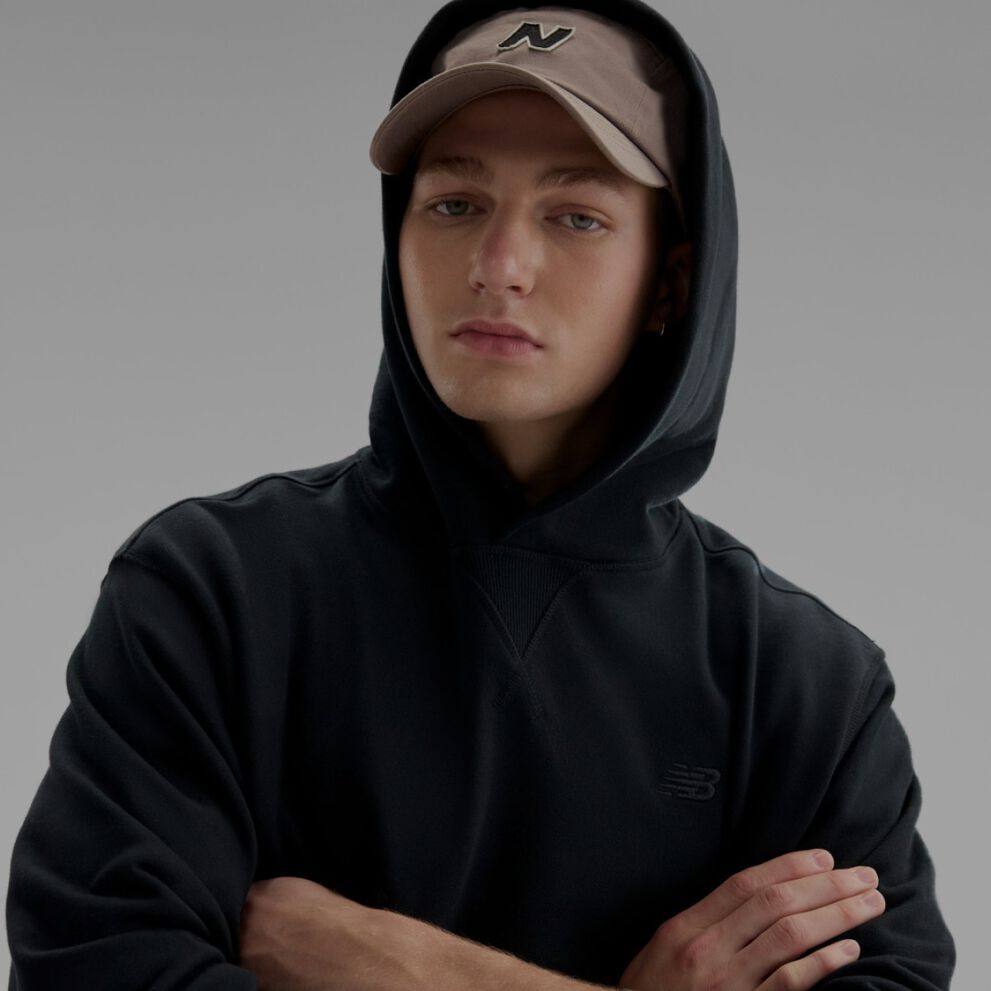 Close-up of a man wearing a black sweatshirt. 