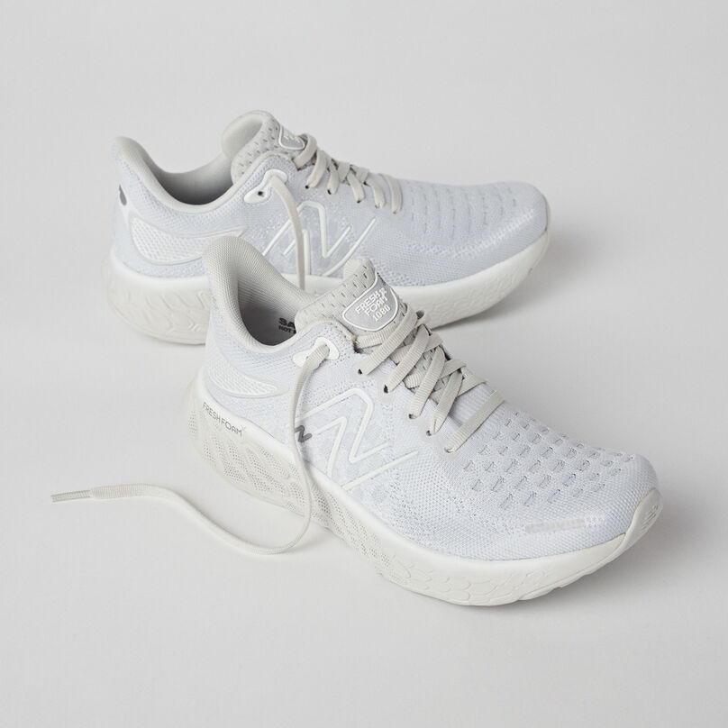 Pair of light grey running shoes showing the lateral sides.