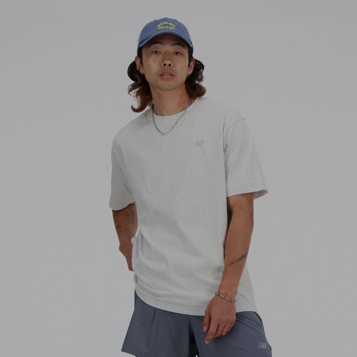 A man in a grey New Balance t-shirt.