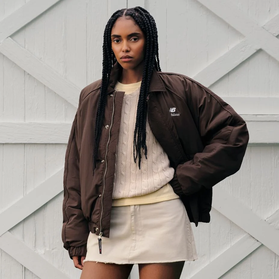 A person wearing Made in USA apparel standing in front of a barn. 
