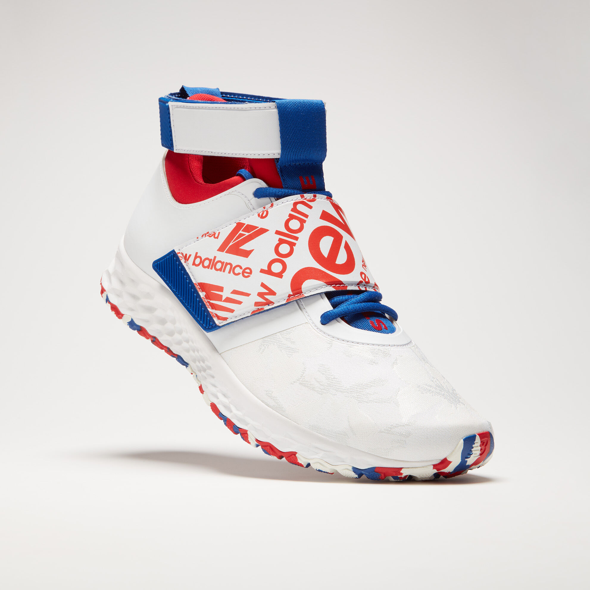 White shoe with red and blue accents, floating toe down, on a light grey background