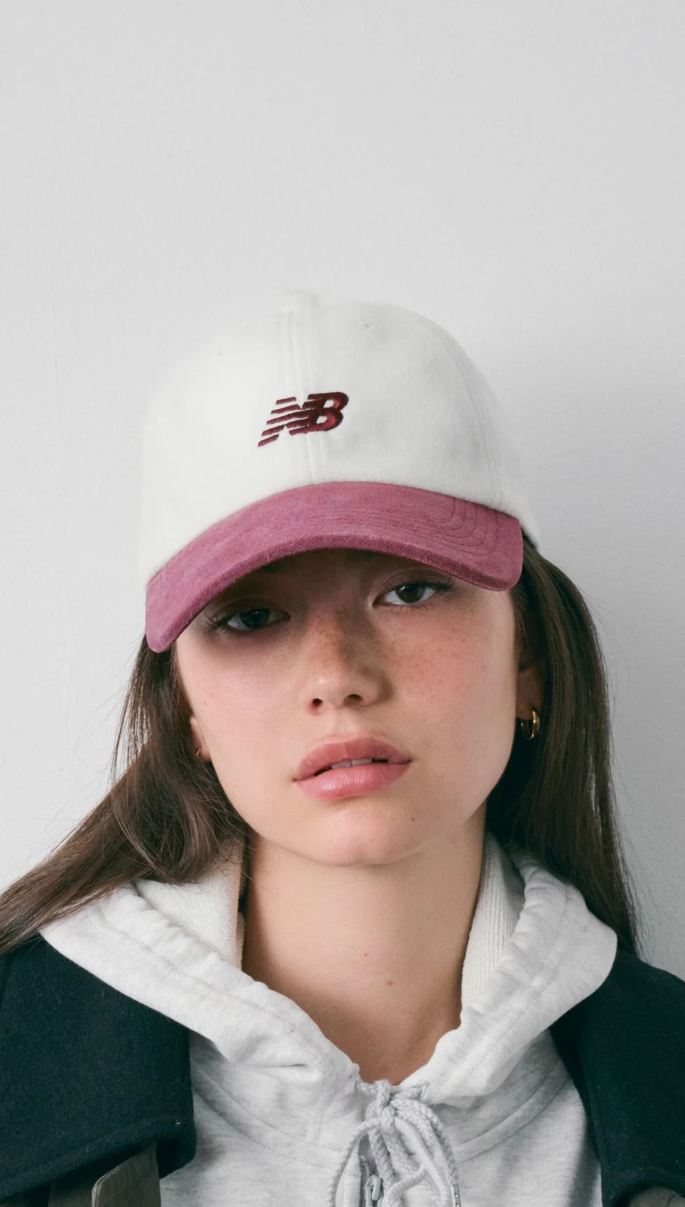 A woman wearing a ‘47 New Balance hat in studio.