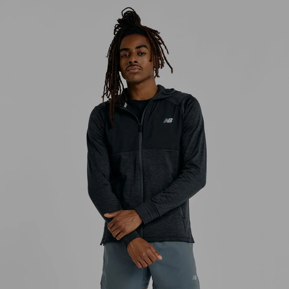 A man wearing a black New Balance jacket.