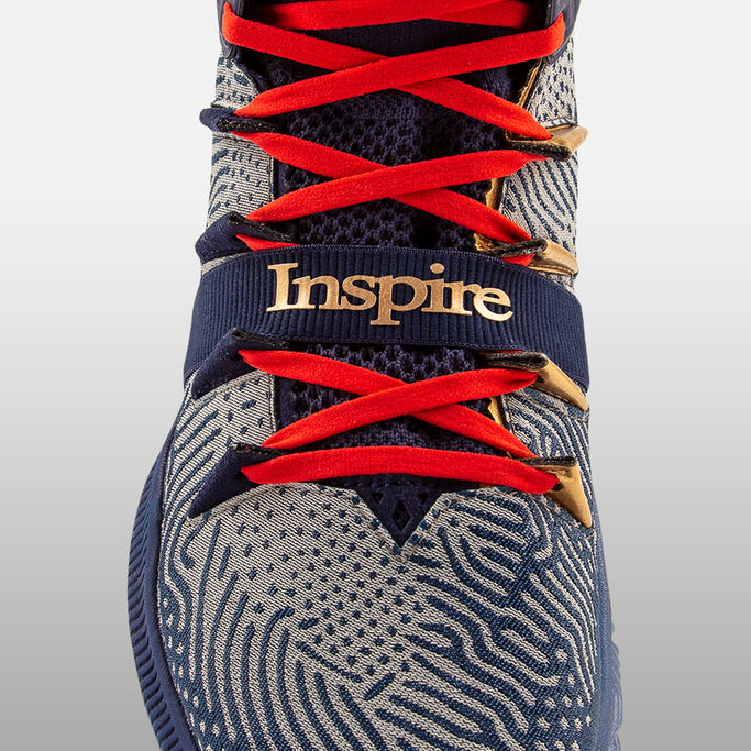 Close up of shoe upper with "Inspire” graphic across foot