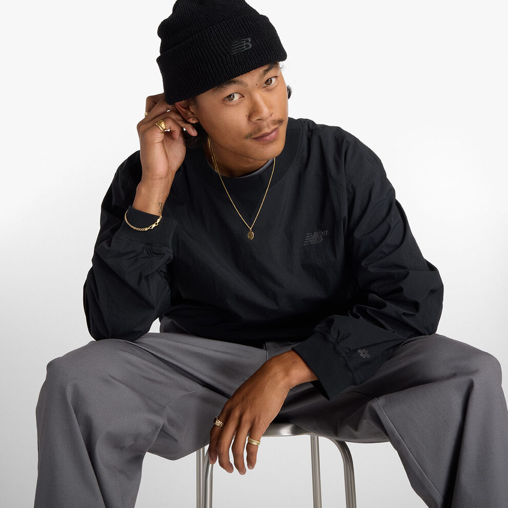 Skateboarder Patrick Praman sitting in a studio wearing Numeric apparel. 
