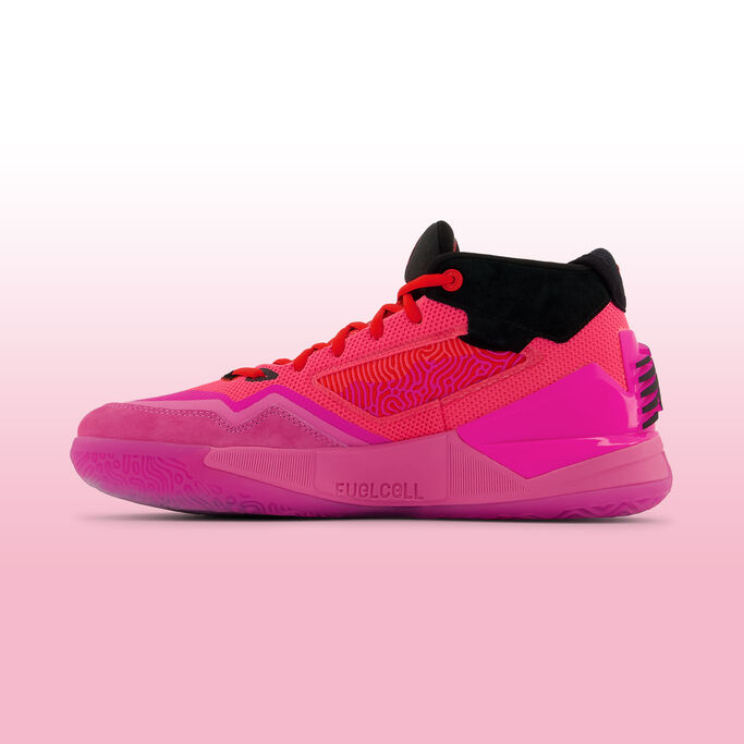 Pink and orange basketball shoe sitting on a white and pink gradient background.