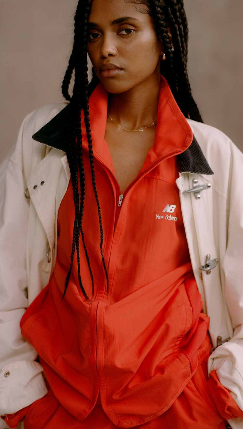 A cropped image of a woman wearing Made in USA apparel in front of a studio background. 