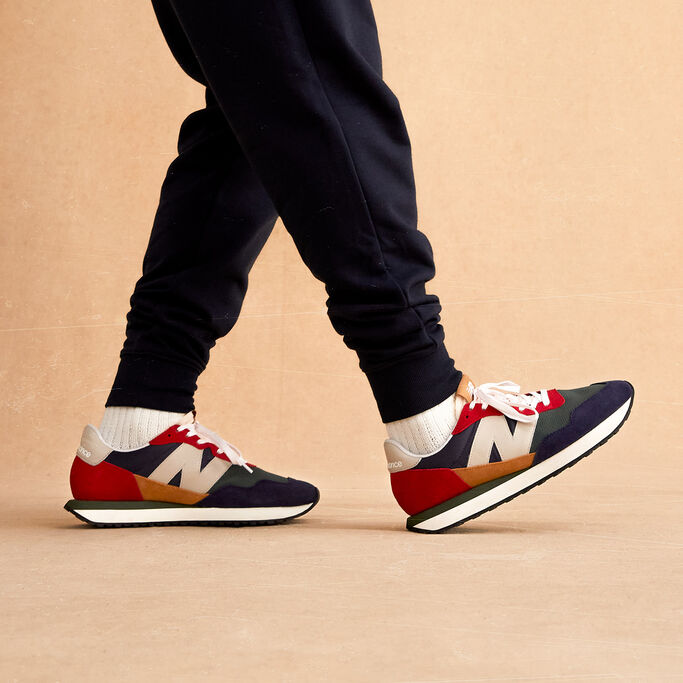Male walking, cropped waist down, showing side profile of the shoes