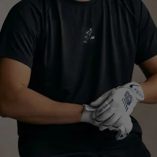A pair of black and yellow baseball gloves. 