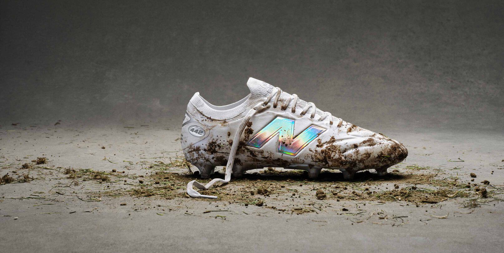 The white cleats with blue accents with dirt on them.